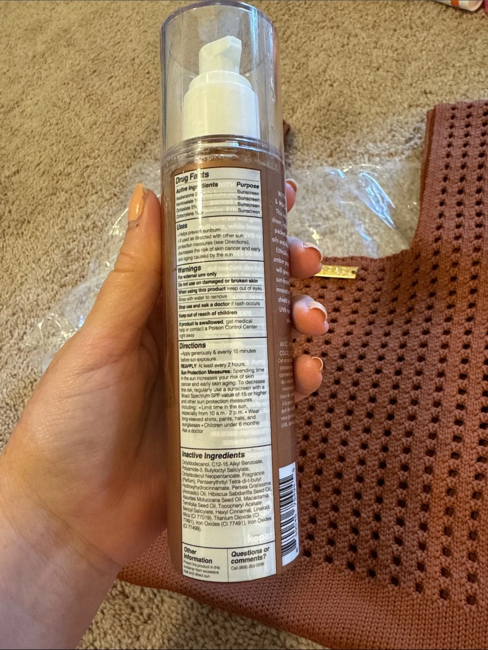 Kopari golden amber body glow sunscreen with rust knit tote